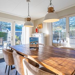 Stylish dining area in Holiday Home Honeysuckle 57, De Koog, Texel with garden views and plenty of natural light.