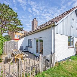 Spacious terrace at 32a Castor vacation home in De Koog, Texel, ideal for outdoor breakfasts.