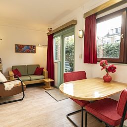 Cozy living room in Schanulleke, De Koog, Texel, vacation home with comfortable seating and dining area.