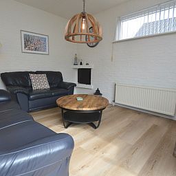 Intimate sitting area in Holiday Home Stappeland 205, De Koog, Texel with comfortable sofas and cozy furnishings.