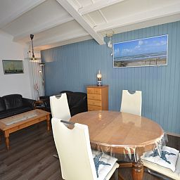 Cozy living room of Motel Texel - Apartment 315/1T, De Koog, Texel with inviting seating and beach theme.
