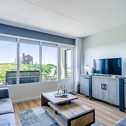 Stylish living room of Apartment Juliana 042 overlooking De Koog, Texel, ideal for a relaxing stay.