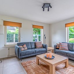Cozy living room in Holiday home Kamperfoelie 69 with sauna, De Koog, Texel, with comfortable sofas and lots of light.