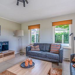 Modern seating area in Holiday home Honeysuckle 69 with sauna, De Koog, Texel, overlooking the garden.