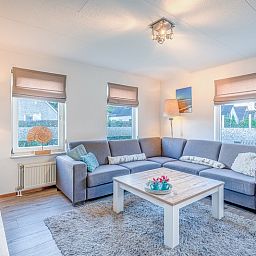 Cozy living room of Holiday home Kamperfoelie 87 in De Koog Texel with comfortable seating area.