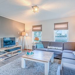 Modern living room with TV in Holiday home Honeysuckle 87, De Koog Texel, ideal for relaxation.