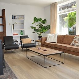Modern sitting area in Plevierstraat 24 - Tuunwoal vacation home, De Koog, Texel with comfortable sofa.