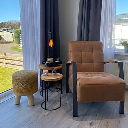 Stylish sitting area with armchair in Chalet Bregkoog 94, De Koog, Texel on Chaletpark Bregkoog.
