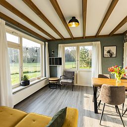 Cozy living room of De Koperwiek in De Koog Texel overlooking the garden.