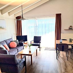 Bright living space in Motel Texel Apartment (W), De Koog, with modern furniture and terrace views.