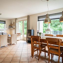 Spacious living room in Villa 6 persons with 2 bathrooms, De Koog, Texel. Comfortable sitting area and dining area in vacation home.