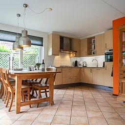 Dining area and kitchen in Villa 6 persons with 2 bathrooms, De Koog, Texel. Cozy vacation home on the Wadden Islands.