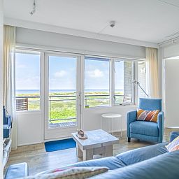 Bright living room of Apartment Juliana 112 Zeezicht in De Koog, Texel overlooking nature.