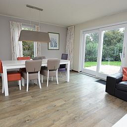 Dining room in Holiday home Stappeland 76, De Koog, Texel overlooking green garden.