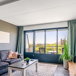 Comfortable sitting area in Apartment Juliana 094 Island and Sea View, De Koog, Texel with a view of nature.