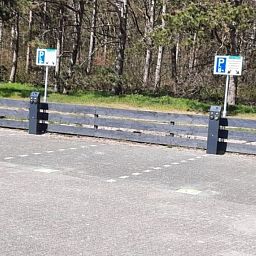 Parking at Apartment Dorpsstraat 245, De Koog, Texel with green surroundings.