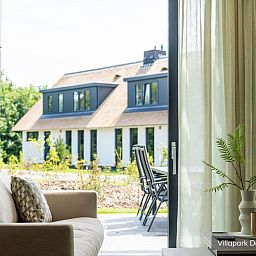 Interior Luxury family villa 8p in De Koog, Texel with cozy living room and views of nature.