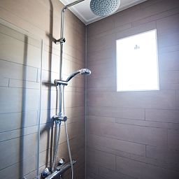 Modern shower in Villa 3, vacation home De Koog Texel, with stylish finish.