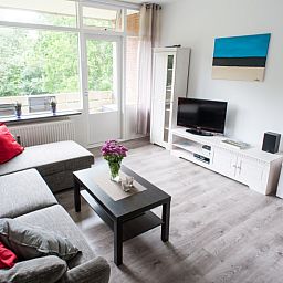 't Kerckeland - Apartment Kerckeland 92, De Koog: Spacious living room with lots of natural light and access to balcony.