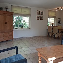 Spacious dining room in Pauwenhof Texel vacation home in De Koog with lots of natural light.