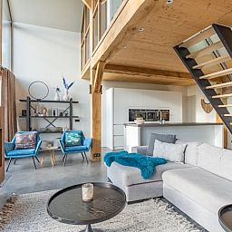 Stylish living room with open kitchen in Holiday home in De Koog Texel, ideal for a relaxing vacation on the Wadden Islands.