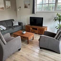 Cozy living room of Stormvogel, vacation home in De Koog, Texel with comfortable seating area.
