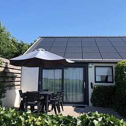 Sunny terrace of Bungalow 2 in De Koog, Texel, ideal for relaxing in nature.