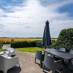Beautiful view from the terrace of Bungalow 2 in De Koog, Texel, with vast fields.