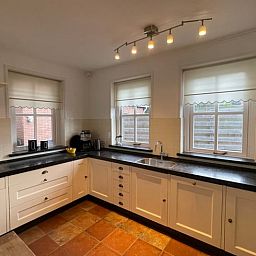 Stylish kitchen in cottage in Den Burg, Texel with modern appliances and lots of light.