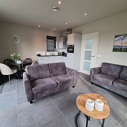 Comfortable sitting area in Schoonoordsingel 29a, vacation home in Den Burg, Texel, ideal for relaxation.