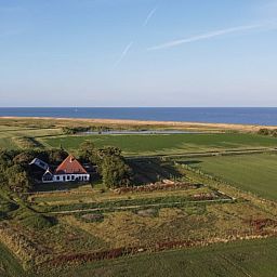 Aerial view of Holiday home in Oosterend, Texel. Beautiful view of sea and nature around the vacation home.