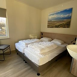 Comfortable bedroom in vacation home Vuurtoren, Oosterend, Texel with double bed.