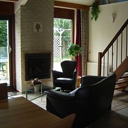 Cozy living room with fireplace in Holiday home Gortersmient 356, De Dennen, Texel. Ideal for cozy evenings on the Wadden Islands.
