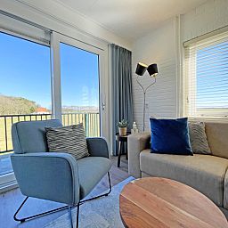 Zithoek met uitzicht in Appartement Bos en Duin 30, De Dennen, Texel, ideaal voor ontspanning met natuurzicht.