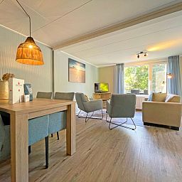 Spacious sitting area in Apartment Bos en Duin 22, De Dennen, Texel overlooking the green surroundings.
