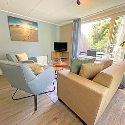 Bright living room in Apartment Bos en Duin 22, De Dennen, Texel with access to the terrace.