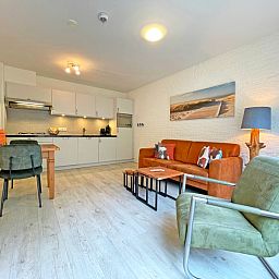 Cozy sitting area in Apartment Bos en Duin 08, De Dennen, Texel, overlooking the green surroundings.