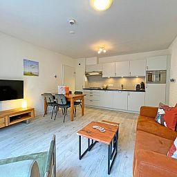 Bright living room of Apartment Bos en Duin 08, De Dennen, Texel, with access to nature.