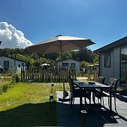 Enjoy the terrace at Chalet Wulk, Vakantiepark de Bremakker, Texel, in the sunny nature of De Dennen.