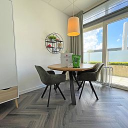 Dining area in Apartment Bos en Duin 02, Texel, overlooking the garden and space for cozy meals.