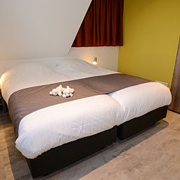 Comfortabele slaapkamer in vakantiehuis Bungalowpark 't Hoogelandt - De Zandkes, De Dennen, Texel.