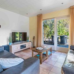 Cozy living room of Landhuis Tempelierweg 22 in Texel with comfortable seating area.