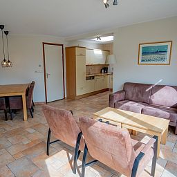 Open kitchen and dining area of Bungalow Uterste Coogh 98 in De Dennen, Texel for comfortable dining.
