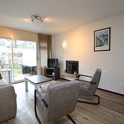 Cozy living room of Holiday home de Parel 196, Texel, with comfortable seating.