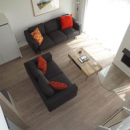 Cozy living room of Holiday home Gortersmient 350 in De Dennen, Texel, with comfortable seating area.