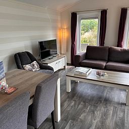 Living room with modern furnishings in Holiday Park de Bremakker, De Dennen, Texel.