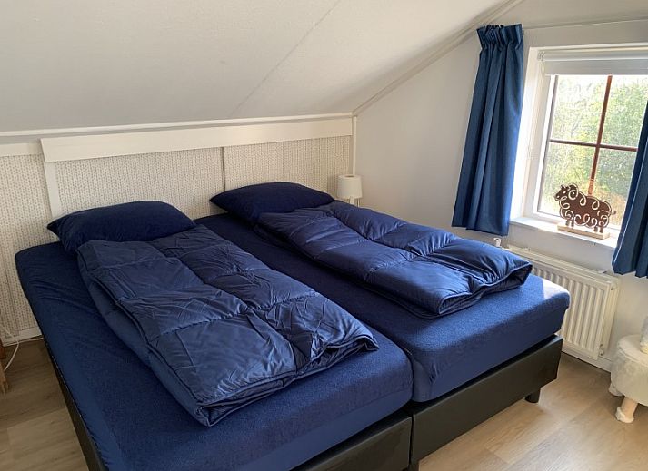 La Guitarra in De Cocksdorp Texel, vacation home with green fence and entrance gate.