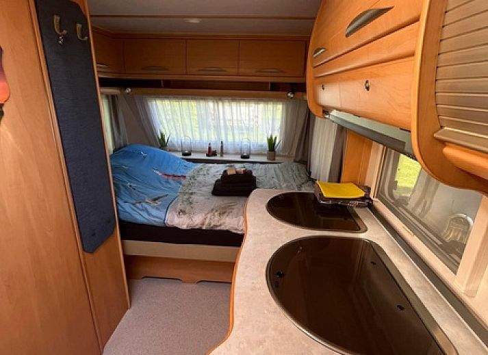 Innenbereich von Caravan Joanneshoeve in De Cocksdorp Texel mit gemuetlicher Essecke und Kueche, ideal fuer einen entspannten Aufenthalt.