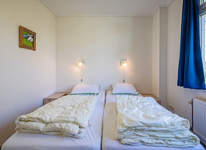 Cozy living room of Holiday home Slufterhoek 034, Texel, with modern furnishings and lots of light.