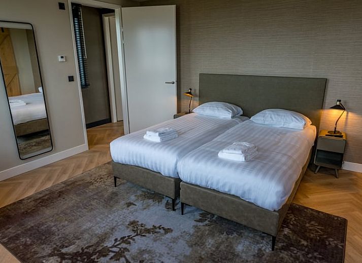 Charmantes Aeusseres des Ferienhauses in De Cocksdorp, Texel, mit roten Dachziegeln.